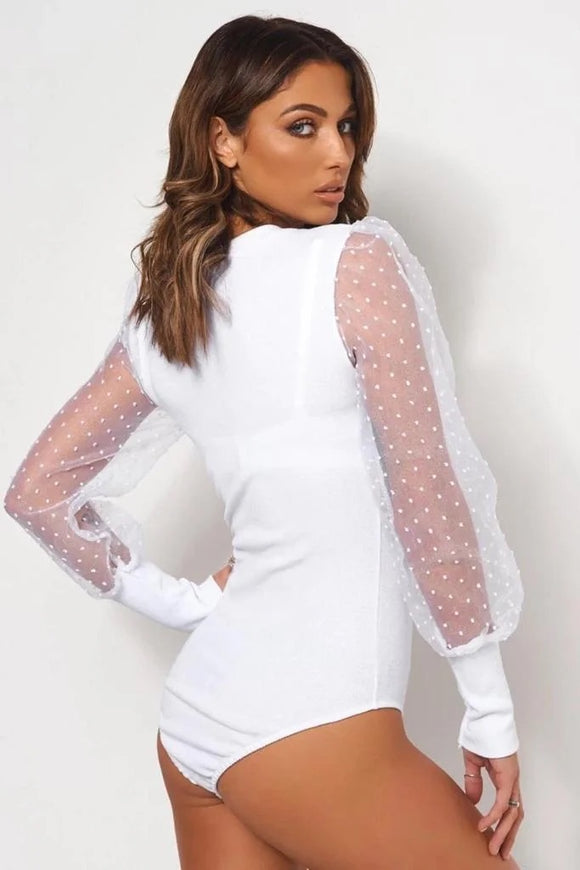 Plain white body suit, with puff polka sleeves.